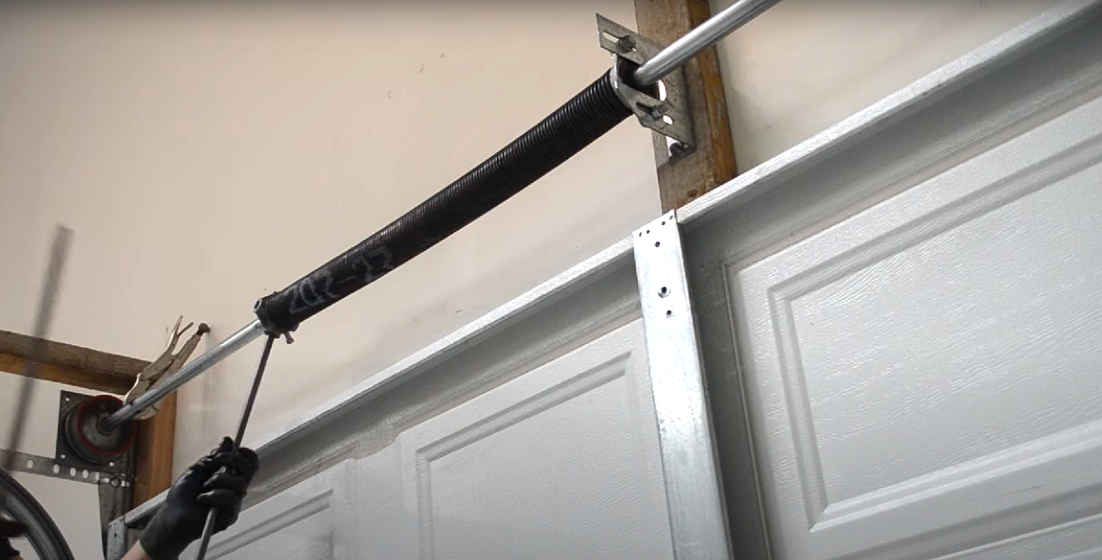 Professional technician performing garage door spring repair in Columbus, Ohio
